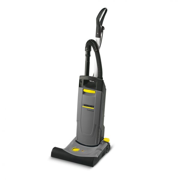 A vertical CV 38/2 - Upright Brush Type Vacuum commercial vacuum cleaner with an attached flexible hose, predominantly grey with yellow accents.